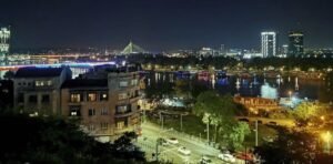 Stunning night panorama of Belgrade with the illuminated Sava river, vibrant city lights, and famous floating river clubs (splavovi).