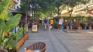Vibrant street cafes and lush greenery at Obilicev venac pedestrian zone in Belgrade, perfect for a sunny day stroll.